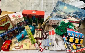Lot 169- Large Lot Christmas New, 4 Christmas ugly sweaters, Artwork, Banners, outside 7 foot banners, 2 sets of Christmas Kitten cards, 17 Christmas CD sets, snowmen, solar stake, believe bells etc, 56 Pieces